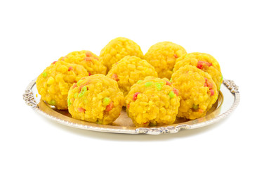 Laddu also know as laddoo, ladoo, laddo are ball-shaped sweets popular in the Indian festivals. Laddu are made of flour, minced dough and sugar with other ingredients. laddu on white background