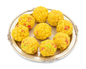 Laddu also know as laddoo, ladoo, laddo are ball-shaped sweets popular in the Indian festivals. Laddu are made of flour, minced dough and sugar with other ingredients. laddu on white background