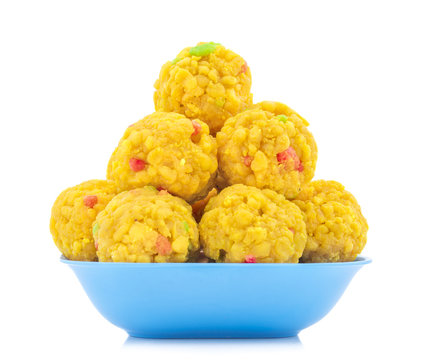 Laddu also know as laddoo, ladoo, laddo are ball-shaped sweets popular in  the Indian festivals. Laddu are made of flour, minced dough and sugar with  other ingredients. laddu on white background Stock