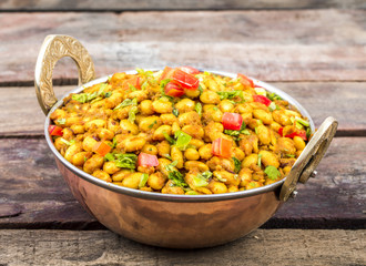 Indian Cuisine Rajma Masala or Rajmah is a South Asian Vegetarian Dish Consisting of White Kidney Beans in a thick gravy with many Indian whole spices and usually served with Chapati and food