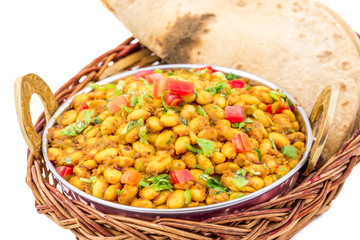Indian Cuisine Rajma Masala or Rajmah is a South Asian Vegetarian Dish Consisting of White Kidney Beans in a thick gravy with many Indian whole spices and usually served with Chapati and food