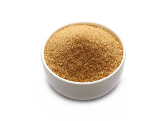 Brown cane sugar in porcelain bowl isolated on white background, sugarcane texture