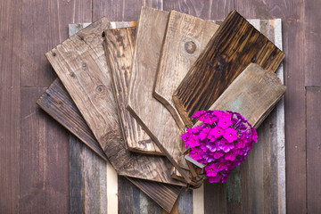 Flower on a rough weathered wooden board. Rustic texture for background