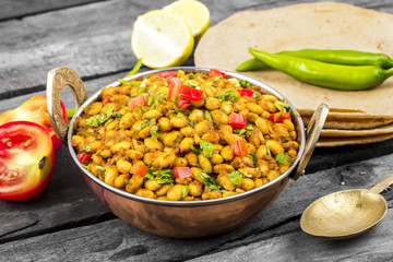 Indian Cuisine Rajma Masala or Rajmah is a South Asian Vegetarian Dish Consisting of White Kidney Beans in a thick gravy with many Indian whole spices and usually served with Chapati and food
