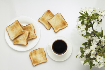 Fototapeta na wymiar Toast, coffee and blossoming cherry branches on a white background.