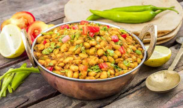 Indian Cuisine Rajma Masala or Rajmah is a South Asian Vegetarian Dish Consisting of White Kidney Beans in a thick gravy with many Indian whole spices and usually served with Chapati and food