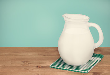 Jug milk on brown wooden table