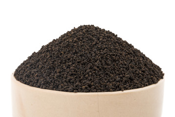 Aromatic Black Tea Loose or Dried Tea Leaves in Bowl isolated on White Background