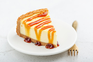 Slice of cheesecake with caramel sauce.