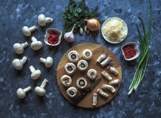 Stuffed mushrooms. Cooking dishes with mushrooms, onions, cheese and herbs. Delicious vegetarian food.