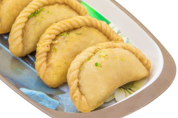 Gujiya or Gujia is a indian sweet dumpling made with suji, Maida or wheat flour and stuffed with khoya. It is common in North India, particularly in Bihar, Uttar Pradesh, Madhya Pradesh or Rajasthan