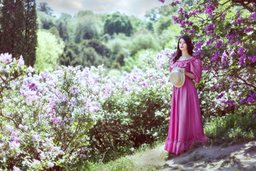 Woman among lilac bushes.