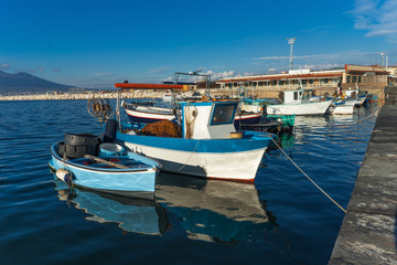 Fototapeta na wymiar Castellammare di Stabia, gulf of Naples, Italy - fishermen boats in the blue sea