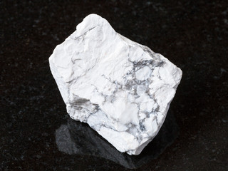 raw Howlite stone on black granite