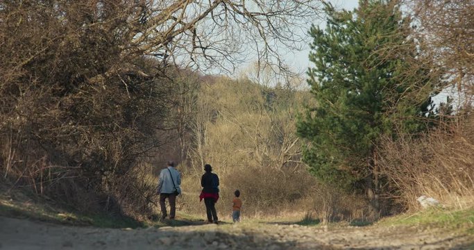 Walk a father with a daughter and a grandson, 4k
