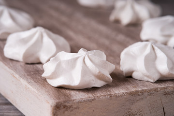Fototapeta na wymiar White marshmallows on wooden cutting board 