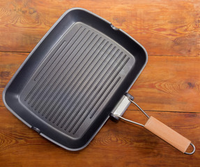 Top view of rectangular grill pan on old rustic table