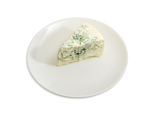 Piece of blue cheese on the white dish