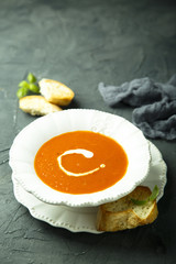 Homemade tomato soup with cream and fresh basil