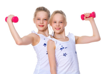 Girls gymnasts show their muscles.