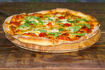 Cooked pizza on the old rustic table at selective focus