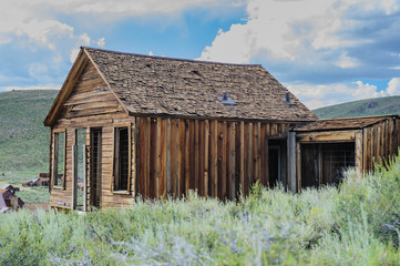 Fototapeta na wymiar Ruined Buildings in the Californian Ghost Town of Bodie. Bodie is one of the best preserved Ghost Towns in America and was founded during the Californian Gold Rush. It was inhabited until the 1970s. 