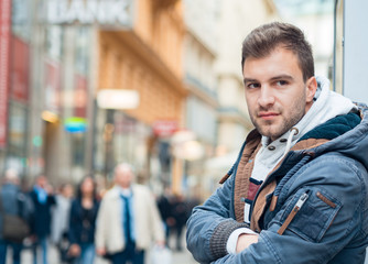 Young gorgeous man . Good looking guy on the street in the city with copyspace for text