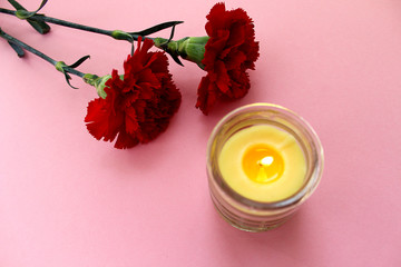 mourning two carnations red with a candle