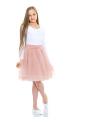 Naklejka premium A little girl fixes her hair.