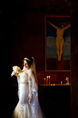 Beautiful young woman standing in the Church after the wedding ceremony.