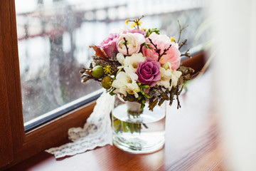 Wedding bridal bouquet of fresh flowers on the windowsill