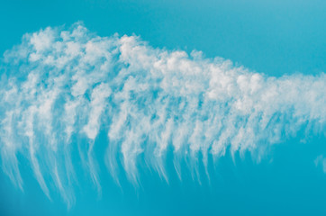 White clouds shape of a wing on the blue sky