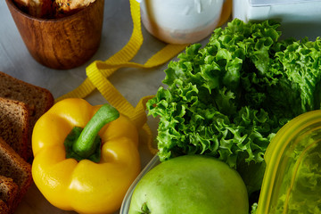 Ingredients for school lunch and plastic container on the table, close-up, selective focus