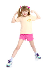 A little girl shows her muscles.