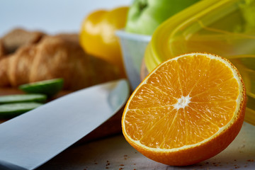 Fresh ripe orange halves on light grey background, selective focus