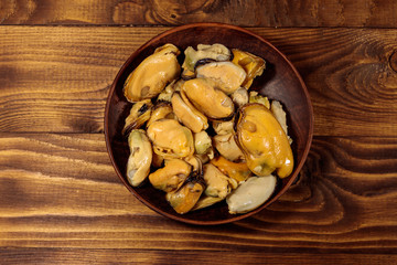 Marinated mussels on wooden table
