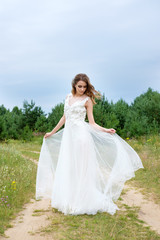 Fototapeta na wymiar young pretty bride in white wedding dress outdoors, make up and hairstyle