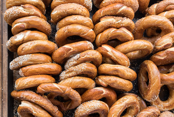 Background of fresh sesame and poppy seeds bagels for sale at local farmers market