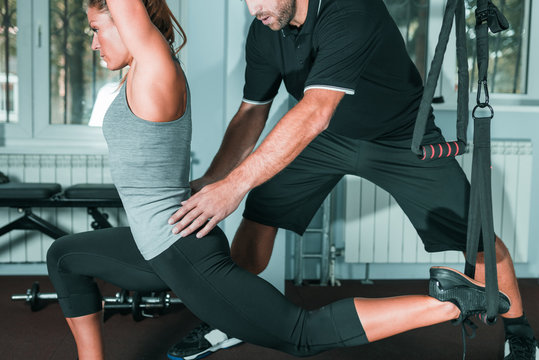 Personal trainer with woman in the gym