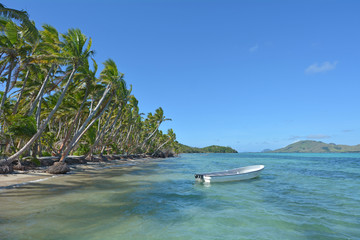 White fishing boat on a tropical island Fiji