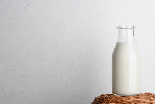 Bottle of milk on wicker basket with white background as copy space