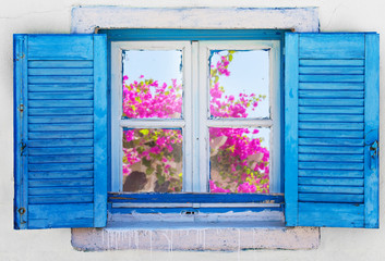 Fototapeta na wymiar Beautiful vintage Greek window with blue shutters. Typical Greek picture.