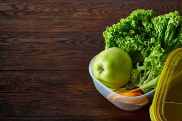 Healthy lunch prepared in small plastic container, top view, close-up.