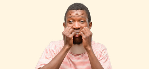 Injured african black man wearing neck brace terrified and nervous expressing anxiety and panic gesture, overwhelmed