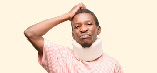 Injured african black man wearing neck brace doubt expression, confuse and wonder concept, uncertain future