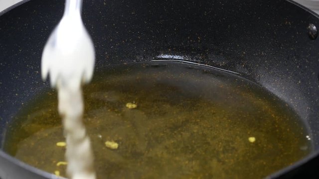 cooking deep batter-fried prawns , put shrimps with flour powder into the boiled food palm oil in black teflon pan high temperature