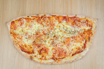 Pizza delicious classic style on wooden table background. Fresh food variety, closeup top view promotional photo. Italian traditional culture