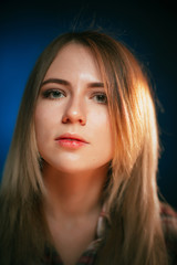 Fototapeta premium portrait smiling girl on blue background in studio