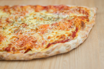 Pizza delicious classic style on wooden table background. Fresh food variety, closeup top view promotional photo. Italian traditional culture