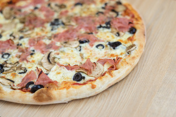 Pizza delicious classic style on wooden table background. Fresh food variety, closeup top view promotional photo. Italian traditional culture